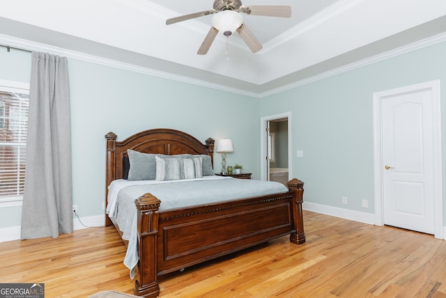 bedroom featuring light wood-style flooring, baseboards, and ornamental molding