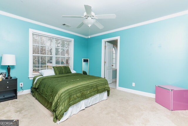 carpeted bedroom featuring visible vents, a ceiling fan, ensuite bath, crown molding, and baseboards