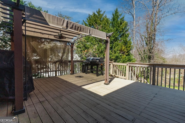 view of side of home featuring stairway, a wooden deck, a chimney, a lawn, and brick siding