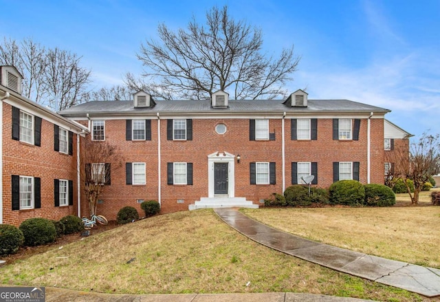 view of front of home featuring brick siding and a front yard