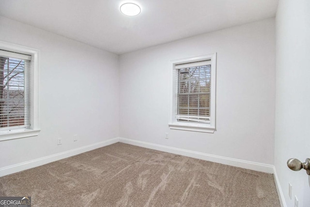 empty room with baseboards and carpet floors