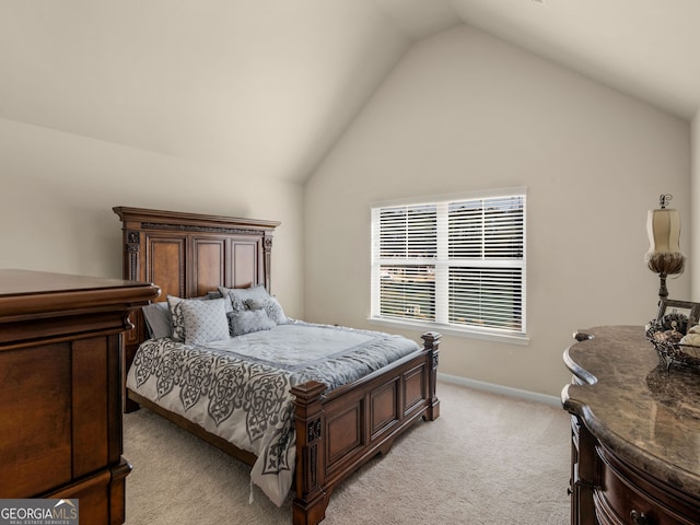 bedroom featuring light carpet, baseboards, and vaulted ceiling