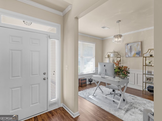 foyer entrance featuring visible vents, ornamental molding, wainscoting, a chandelier, and dark wood-style flooring