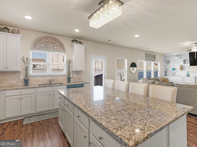 kitchen with dark wood-style floors, open floor plan, white cabinets, and a kitchen island