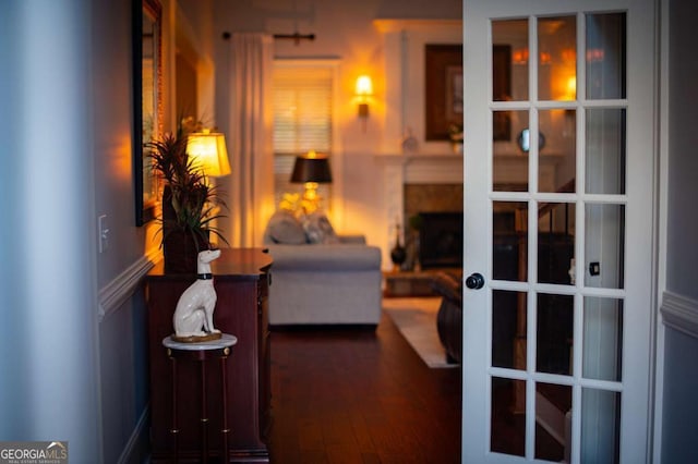 hall with dark wood finished floors and french doors