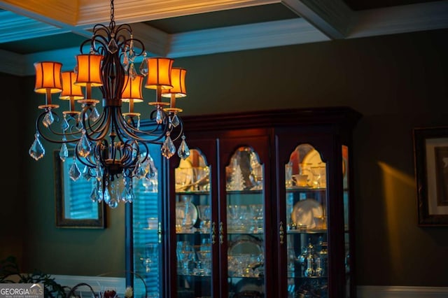 interior details with crown molding and an inviting chandelier