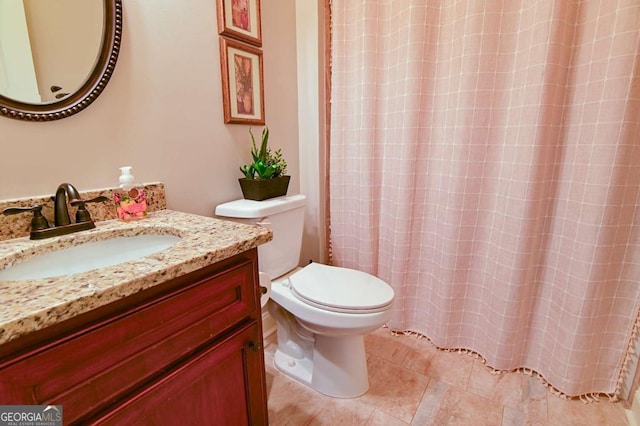 bathroom featuring vanity, tile patterned floors, curtained shower, and toilet