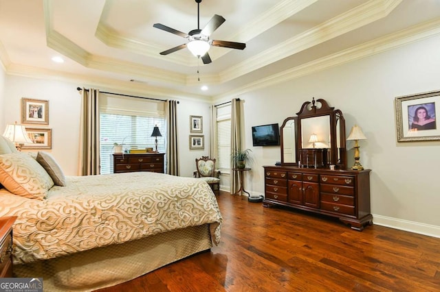 bedroom with a tray ceiling, baseboards, dark wood-type flooring, and ornamental molding