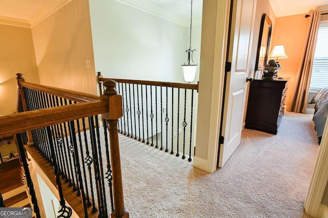 hallway featuring carpet, crown molding, and an upstairs landing