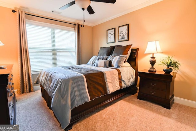 carpeted bedroom featuring visible vents, baseboards, ceiling fan, and crown molding