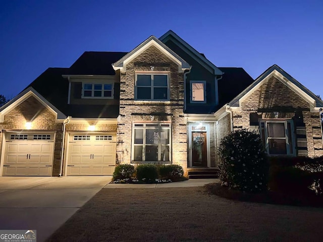 view of front of property featuring stone siding and driveway