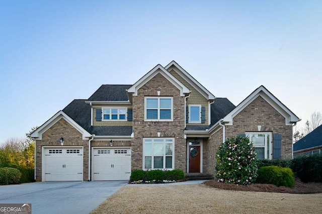 craftsman inspired home featuring brick siding, driveway, and roof with shingles