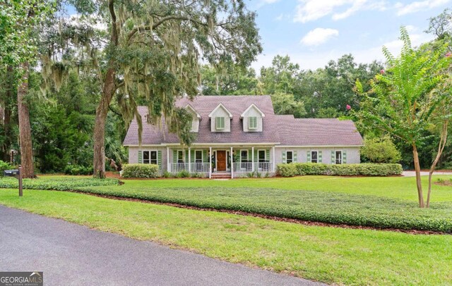 cape cod home with a porch and a front yard