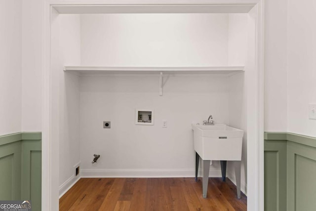 laundry room with wood finished floors, laundry area, electric dryer hookup, washer hookup, and hookup for a gas dryer