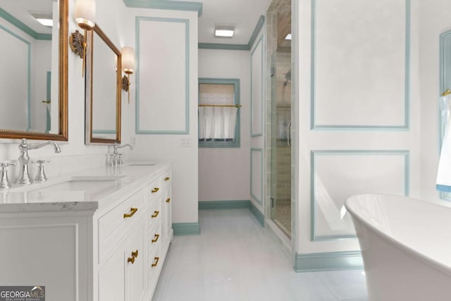 full bath featuring double vanity, a shower stall, a freestanding tub, and a sink