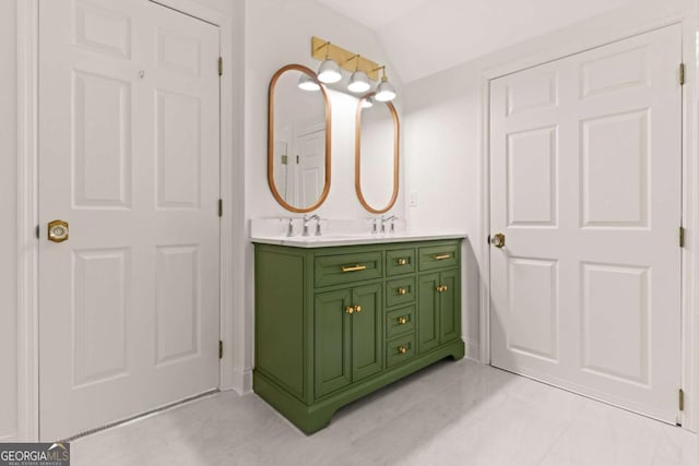 bathroom featuring double vanity, a sink, tile patterned flooring, and vaulted ceiling
