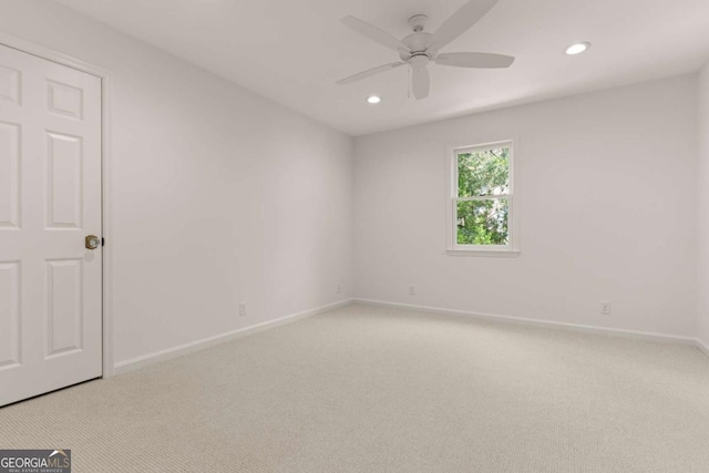 empty room featuring light carpet, recessed lighting, baseboards, and ceiling fan