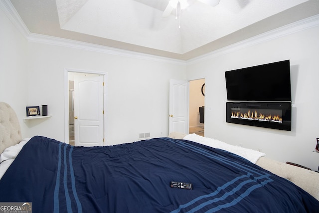 4809 Shae Ct Unit 5, Powder Springs, GA 30127 - bedroom featuring ensuite bathroom, visible vents, a glass covered fireplace, crown molding, and a raised ceiling