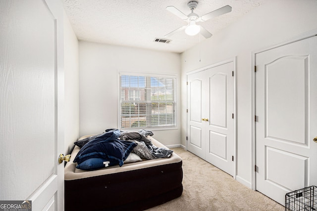 4809 Shae Ct Unit 5, Powder Springs, GA 30127 - bedroom featuring a textured ceiling, baseboards, visible vents, light colored carpet, and ceiling fan