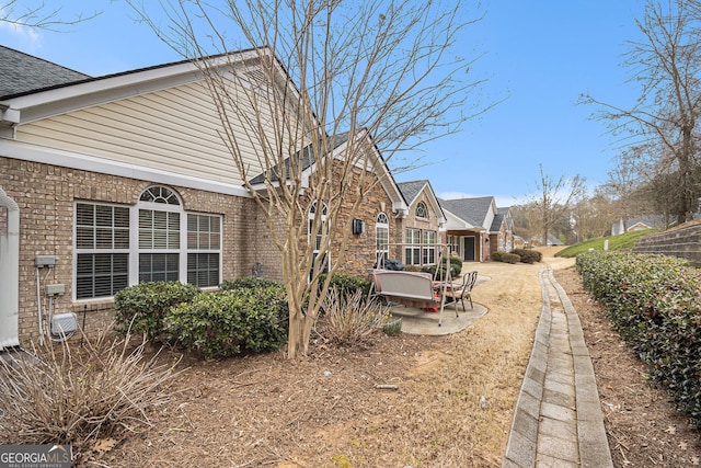 4809 Shae Ct Unit 5, Powder Springs, GA 30127 - view of property exterior with brick siding, roof with shingles, and a patio