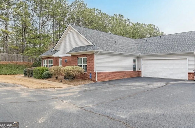 4809 Shae Ct Unit 5, Powder Springs, GA 30127 - view of home's exterior with an attached garage, aphalt driveway, a shingled roof, and brick siding