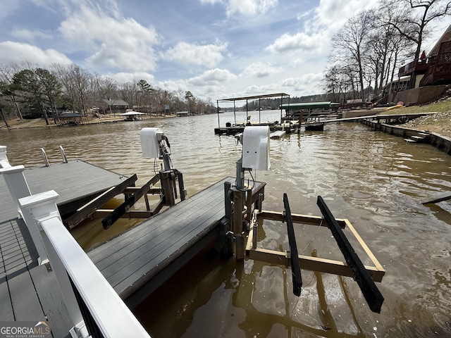 dock area with a water view and boat lift