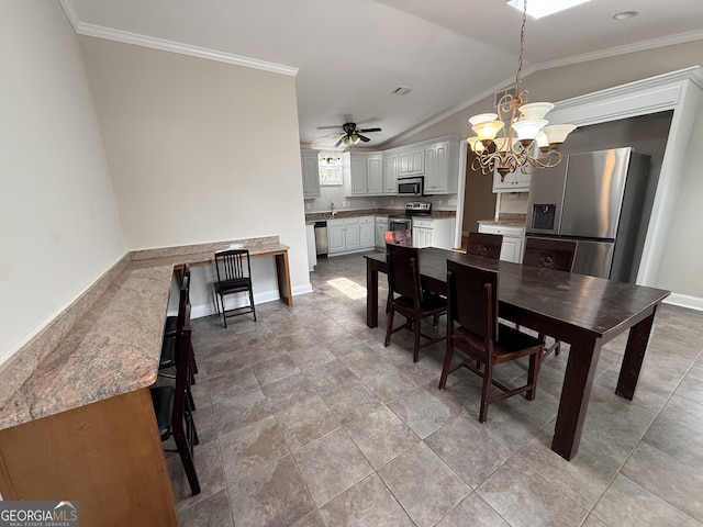 dining space featuring visible vents, ceiling fan with notable chandelier, crown molding, baseboards, and vaulted ceiling