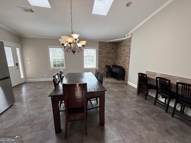 dining area featuring crown molding, a skylight, a notable chandelier, and visible vents