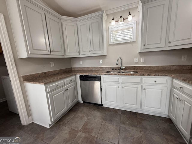 kitchen with dark tile patterned floors, a sink, white cabinetry, and stainless steel dishwasher