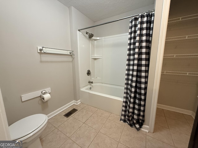 full bathroom with tile patterned flooring, visible vents, toilet, and a textured ceiling