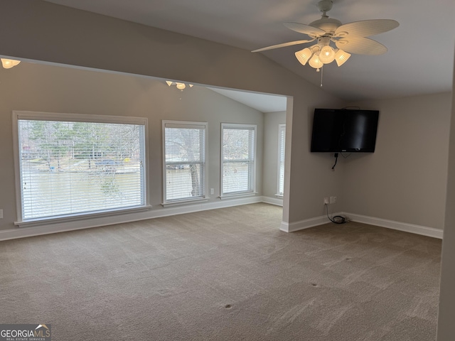 unfurnished living room with baseboards, a ceiling fan, lofted ceiling, and carpet floors