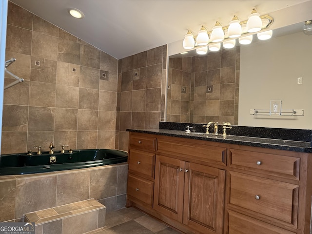 full bathroom with tiled tub, vanity, lofted ceiling, tile patterned floors, and tile walls