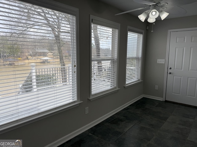 foyer with baseboards and a ceiling fan