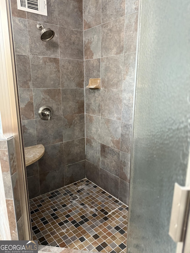 full bathroom with visible vents and a stall shower