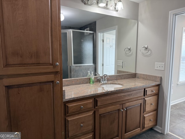 full bathroom with tile patterned floors, a stall shower, and vanity