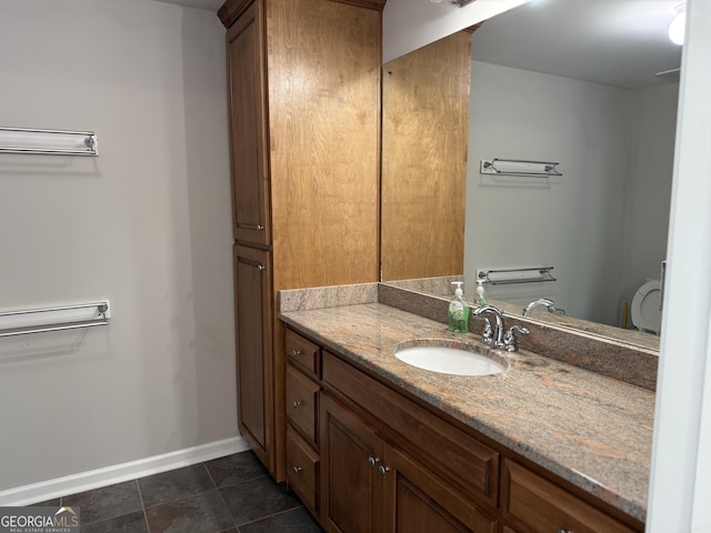 bathroom featuring tile patterned floors, vanity, and baseboards