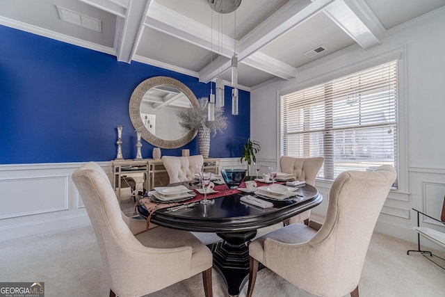 dining room with visible vents, beam ceiling, carpet flooring, a decorative wall, and coffered ceiling