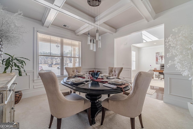 dining room with a decorative wall, light colored carpet, and a wealth of natural light