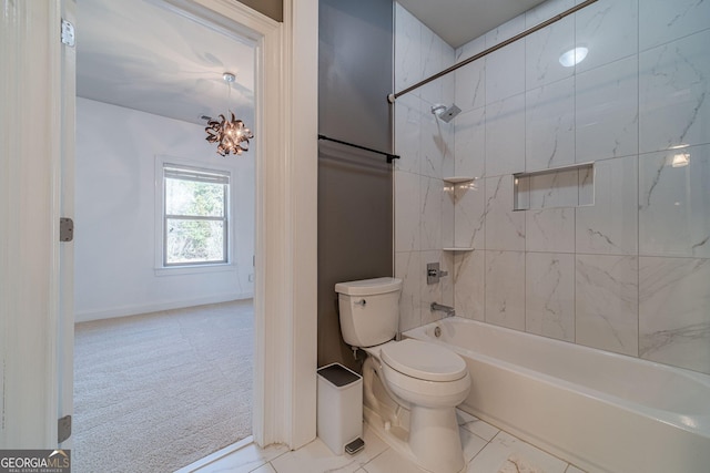 bathroom with a notable chandelier, toilet, marble finish floor, washtub / shower combination, and baseboards