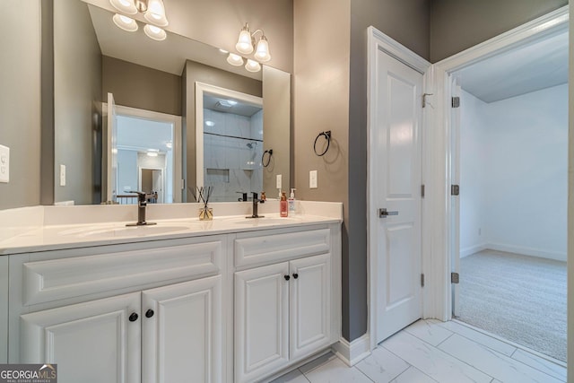 full bath featuring double vanity, baseboards, marble finish floor, and a sink