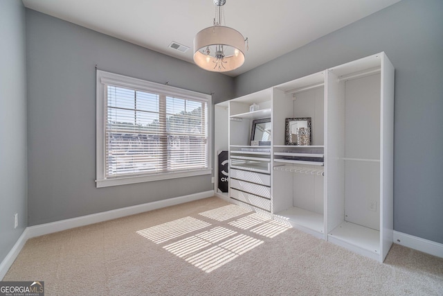 walk in closet featuring visible vents and carpet flooring