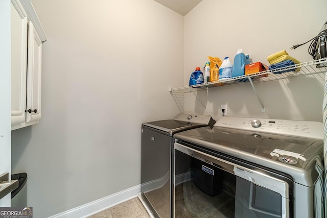 washroom featuring cabinet space, independent washer and dryer, and baseboards