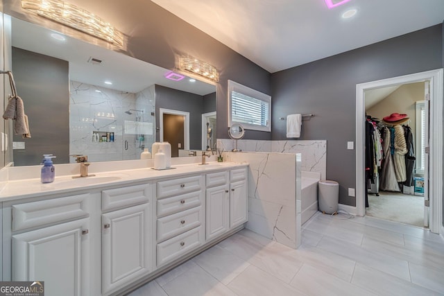 bathroom featuring visible vents, double vanity, a stall shower, a sink, and a bath