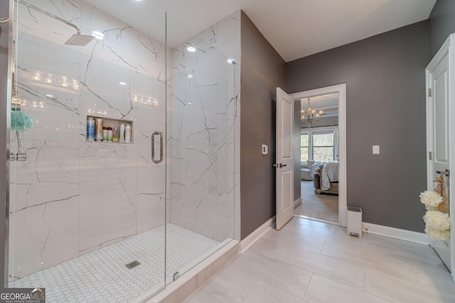 bathroom with a marble finish shower, baseboards, a notable chandelier, and ensuite bath