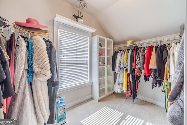 walk in closet with lofted ceiling and carpet floors