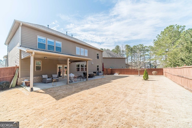 rear view of property featuring a patio area, french doors, and a fenced backyard