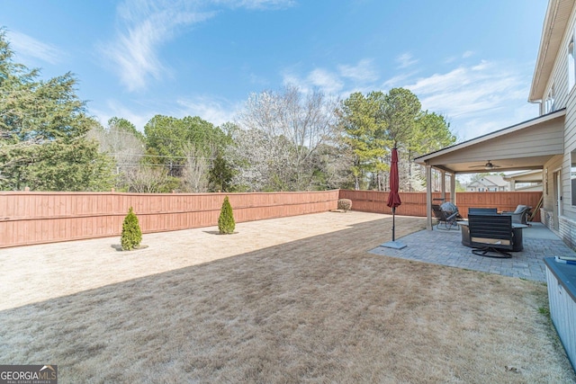 view of yard featuring a ceiling fan, a patio, and a fenced backyard