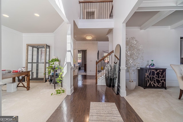 entrance foyer featuring hardwood / wood-style floors, baseboards, recessed lighting, stairs, and crown molding