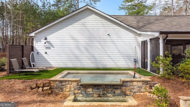 rear view of house with a patio area and a sunroom