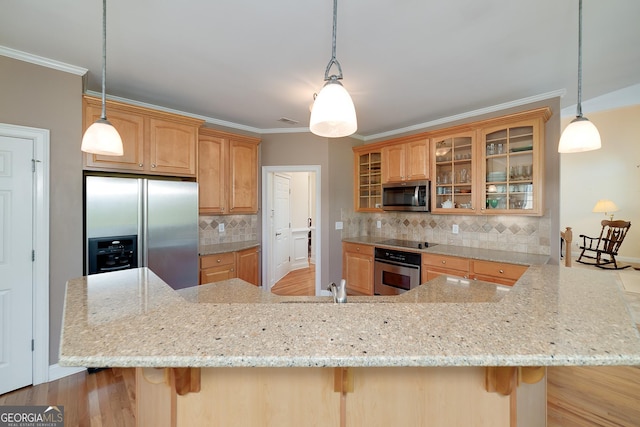 kitchen featuring stainless steel appliances, light stone countertops, a breakfast bar, and ornamental molding